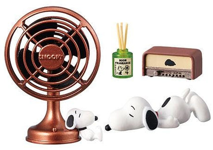a fan, a radio, a bottle of room fragrance, and a Snoopy figurine.