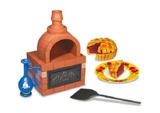 a toy kitchen set with a toy oven, a toy pie, a toy spatula, and a toy blue vase.