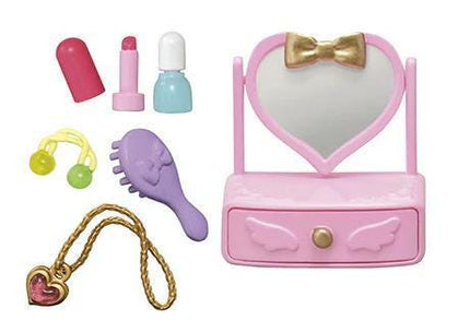 a variety of colorful and whimsical makeup and beauty products, including a pink heart-shaped mirror, a pink vanity, a purple brush, a necklace, and a red lipstick.