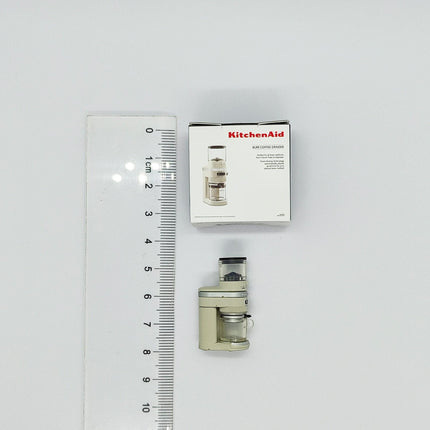 a KitchenAid coffee grinder and its packaging, with a ruler for scale.