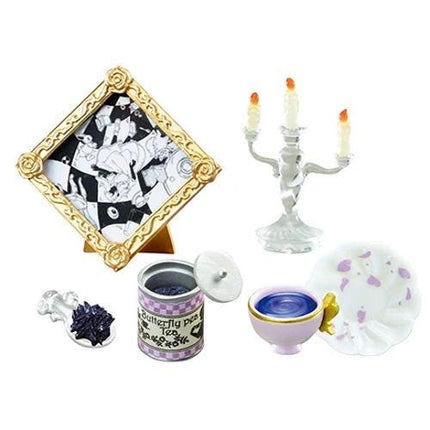 various decorative items, including a picture frame, a candlestick holder, a teapot, a teacup, and a bowl.