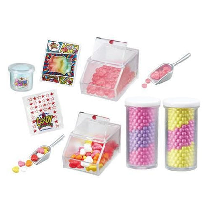 various containers and jars filled with colorful candies, including a clear container, a plastic container, and two jars with different colored candies.