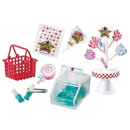 various candy-related items, including a red basket, a clear container, lollipops, and other sweets.