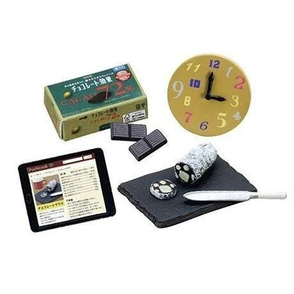 a clock, a tablet, chocolate bars, a knife, and a plate with food.