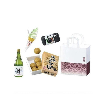 various objects, including a bottle, a camera, a bag, a box of food, and a dessert.