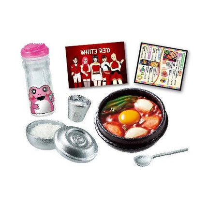various food items and utensils, including a bottle with a cartoon character, a bowl of soup, a cup, a spoon, and a picture of a group of people.