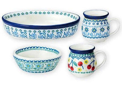 a collection of four ceramic dishes and a mug, all with blue and white floral patterns.