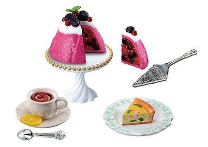 A collection of desserts and tea set on a white background.