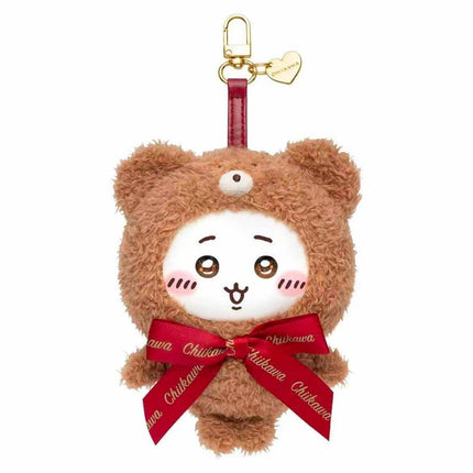 A plush toy of a brown bear wearing a red ribbon and a heart-shaped tag.