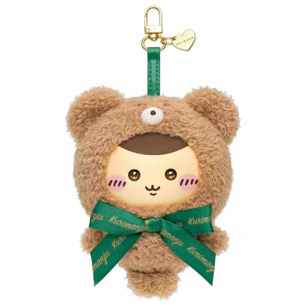 A plush toy of a bear wearing a green ribbon and a heart-shaped tag.
