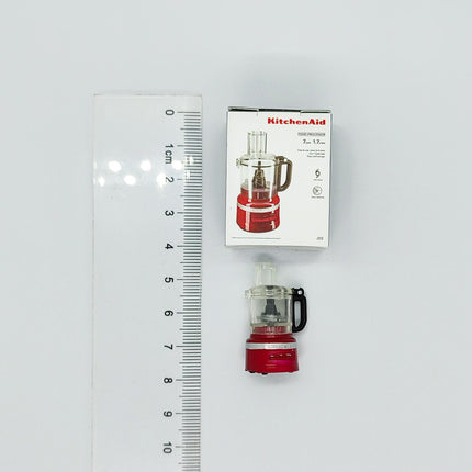 a KitchenAid food processor and its packaging, with a ruler for scale.