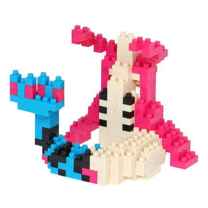 A colorful and playful toy made of various building blocks in different colors, including pink, blue, and white.
