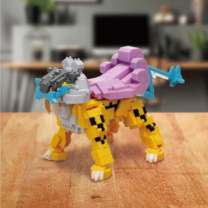 A colorful toy robot made of small building blocks, resembling a Pokémon character, is sitting on a wooden surface.