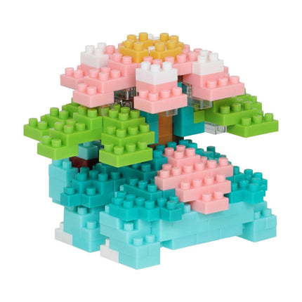 A colorful and intricate toy made of various building blocks in different colors, including pink, green, blue, and yellow.