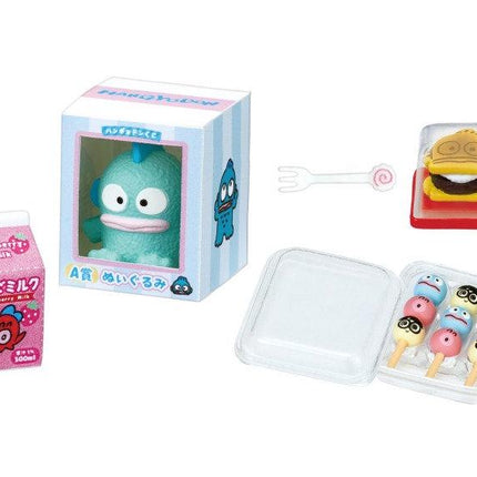 a variety of colorful and whimsical items, including a toy in a box, a carton of milk, a small figurine, and a container of candy.