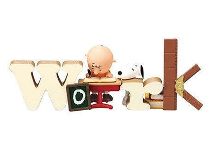 A toy figurine of a character sitting at a desk with a book and a toy dog.