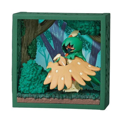 A green-framed display case containing a figurine of a character with orange wings, standing in a forest setting.