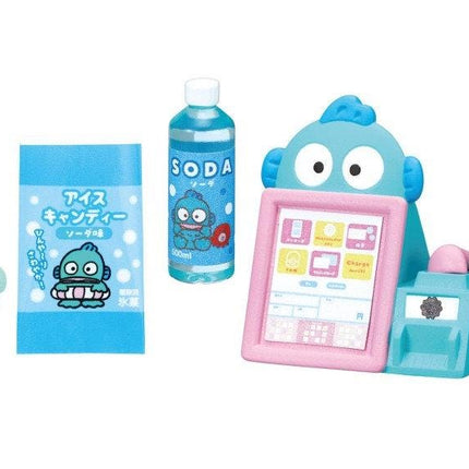 a toy cash register, a bottle of soda, and a lollipop.