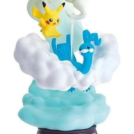 A figurine of Pikachu and Quicksilver, two popular Pokémon characters, are depicted in a whimsical scene with clouds and a rainbow.