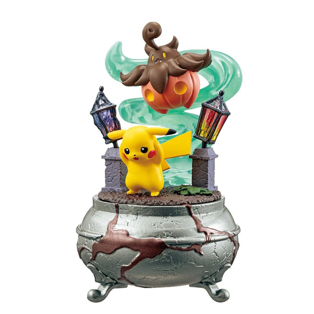 A figurine of Pikachu, a popular Pokémon character, standing on a cracked metal base with a pumpkin and lanterns.