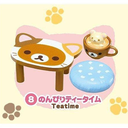 A brown and white cat-shaped table with a cup containing a small brown bear on top, along with a blue circular object and paw prints, all set against a yellow background with paw prints.
