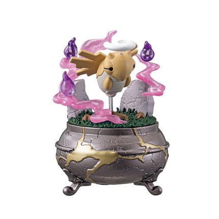 A figurine of a yellow fish with a white hat, surrounded by purple and pink elements, is displayed in a decorative pot.