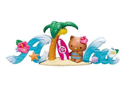 A Hello Kitty figurine is sitting on a sandy beach, surrounded by a surfboard, palm tree, and flowers.