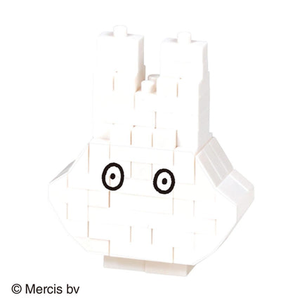 A white, block-like object with two black circles on its eyes, resembling a simple geometric shape or a toy-like structure.