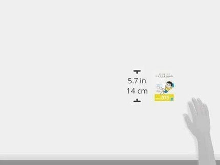 The image is a hand holding a small yellow book with a picture of a person on the cover. The book is 5.7 inches in size.