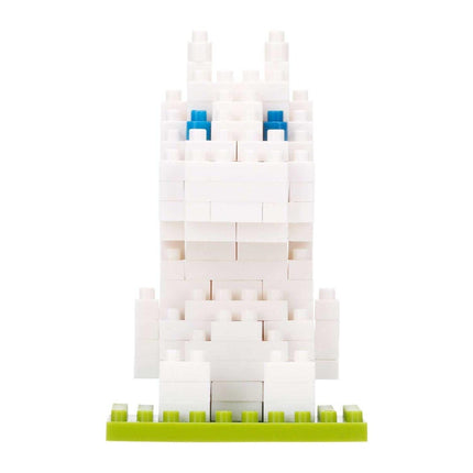 A white Lego bunny with blue eyes is sitting on a green base.