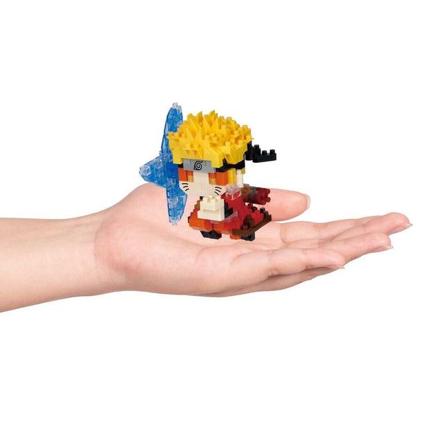 A hand holding a small, colorful, and intricate toy figure.