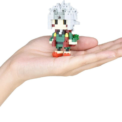 A person's hand holding a small, pixelated figure of a character with a distinctive hairstyle.
