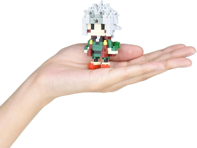 A person's hand holding a small, pixelated figure of a character with a distinctive hairstyle.