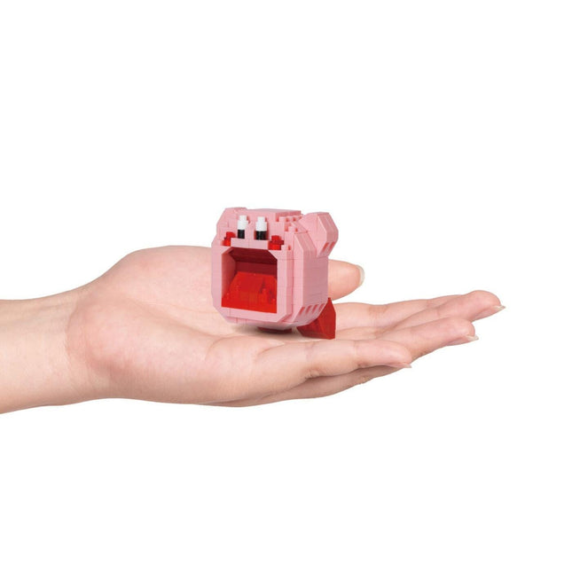 A hand holding a small pink and red toy resembling a character or object.