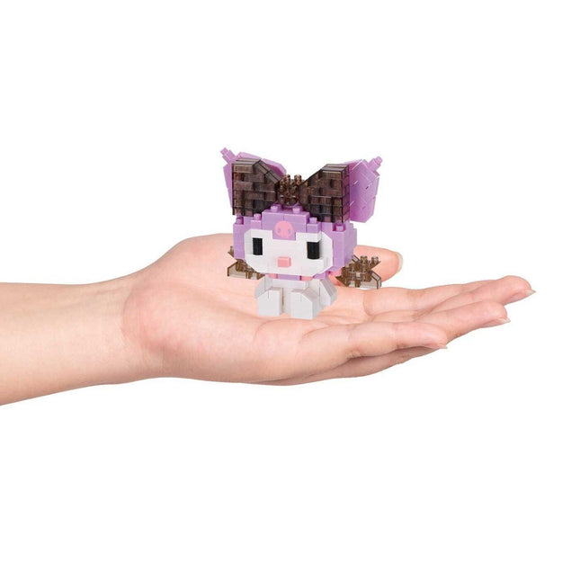 A hand holding a small, colorful, and whimsical toy resembling a character from a popular media franchise.