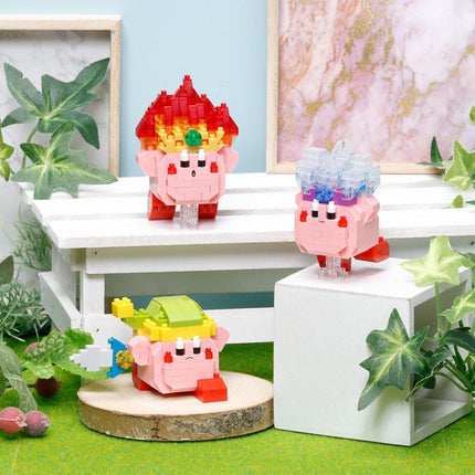 three colorful, pixelated characters, likely from a video game, displayed on a white surface surrounded by greenery.