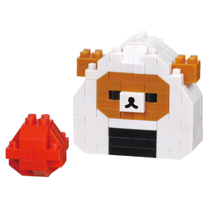 A toy made of white and orange blocks, resembling a bear, with a red ball next to it.