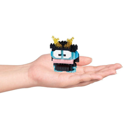 A hand holding a small, colorful, and whimsical toy in the palm.