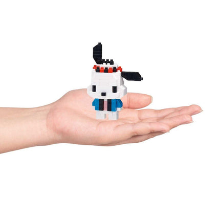 A hand holding a small, white and blue pixelated character.