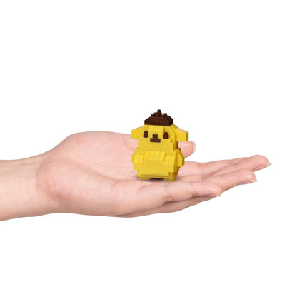 A hand holding a small yellow pixelated character, likely a pixelated dog or cat, against a white background.