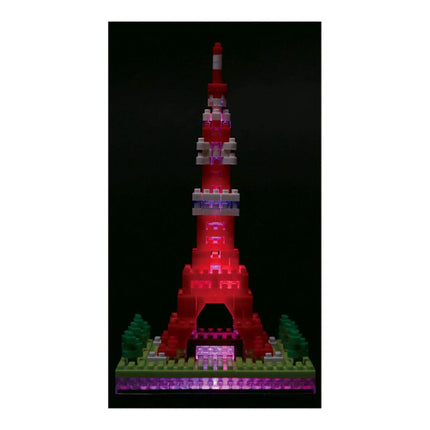 A colorful, illuminated Lego tower stands against a dark background.