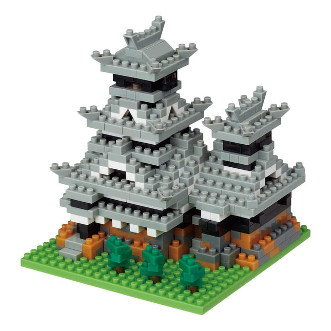 A 3D model of a gray and white castle-like structure made of small building blocks, resembling a Lego or similar construction toy.
