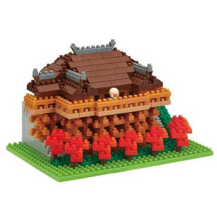 A colorful, intricate model of a house made of small building blocks, with a variety of colors and shapes.