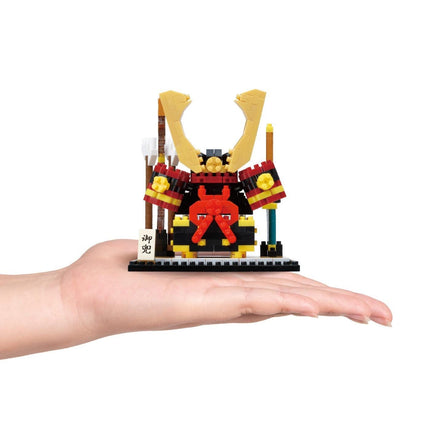 A hand holding a small, colorful toy resembling a warrior or knight figure.