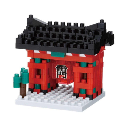 A toy model of a red and black temple with a green tree on the left side, made up of numerous small building blocks.