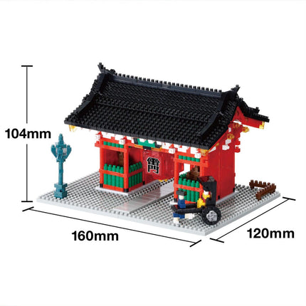 A miniature model of a traditional Japanese temple, made of small building blocks, with a red roof and green accents.