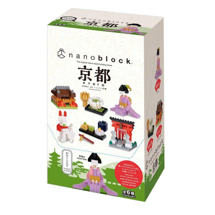 The image is a box containing a set of miniature figurines, including a woman, a cat, and a bird, as well as other small objects.