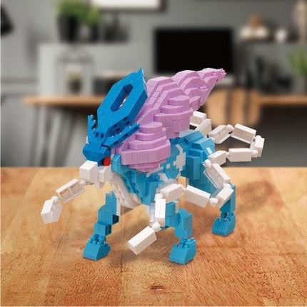 A colorful, 3D-printed toy resembling a dragon or mythical creature, with a mix of blue, pink, and white colors.
