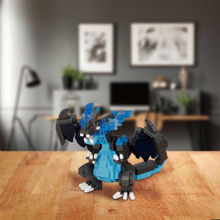 A LEGO dragon figurine is sitting on a wooden surface, with a blurred background that includes a desk, plants, and artwork on the wall.