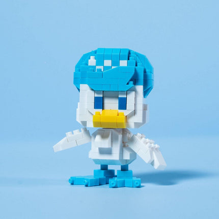 A small, colorful, and whimsical toy figure resembling a duck or a similar aquatic creature, composed of numerous small blue and white building blocks.